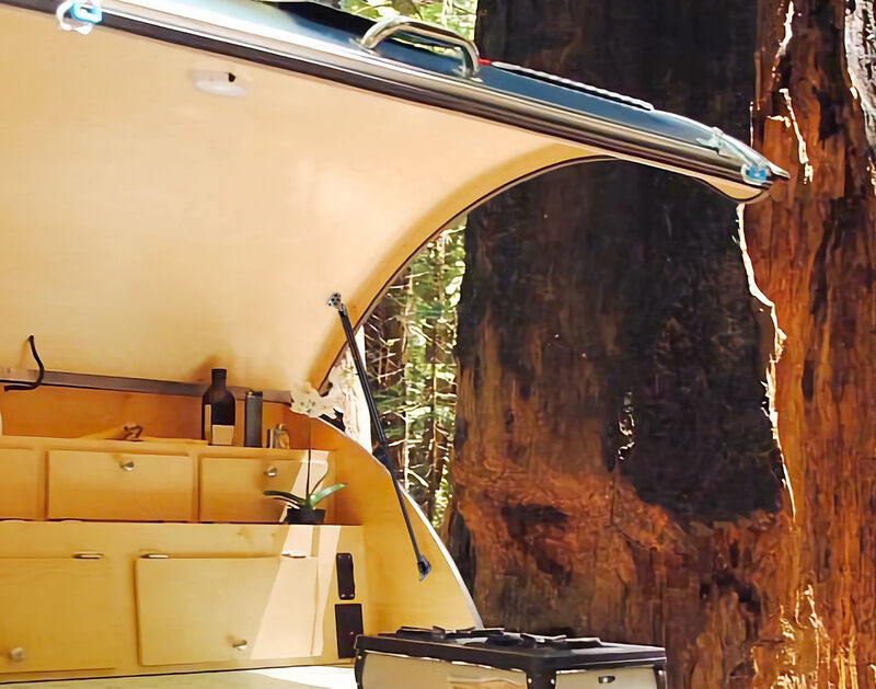 A camper galley hatch held open by a PAMAGOO gas strut in a redwood forest